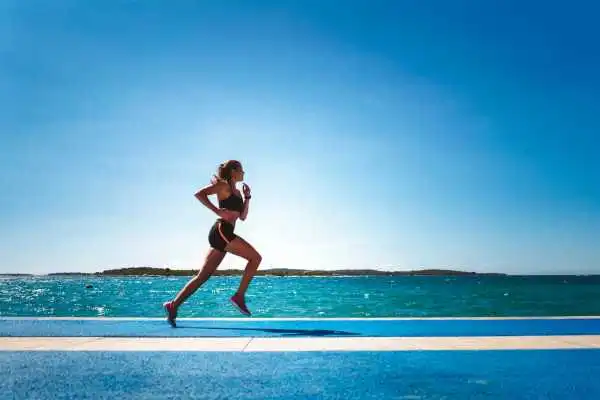 Woman running showing strong leg muscle Wigan